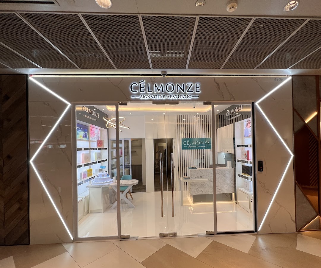 The brightly lit entrance of Celmonze Signature Aesthetic with its prominent signage and glass facade.