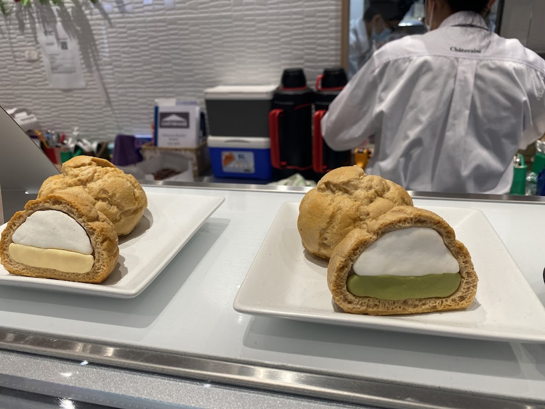 Delicious cream puffs with various fillings displayed on a counter at Châteraisé.