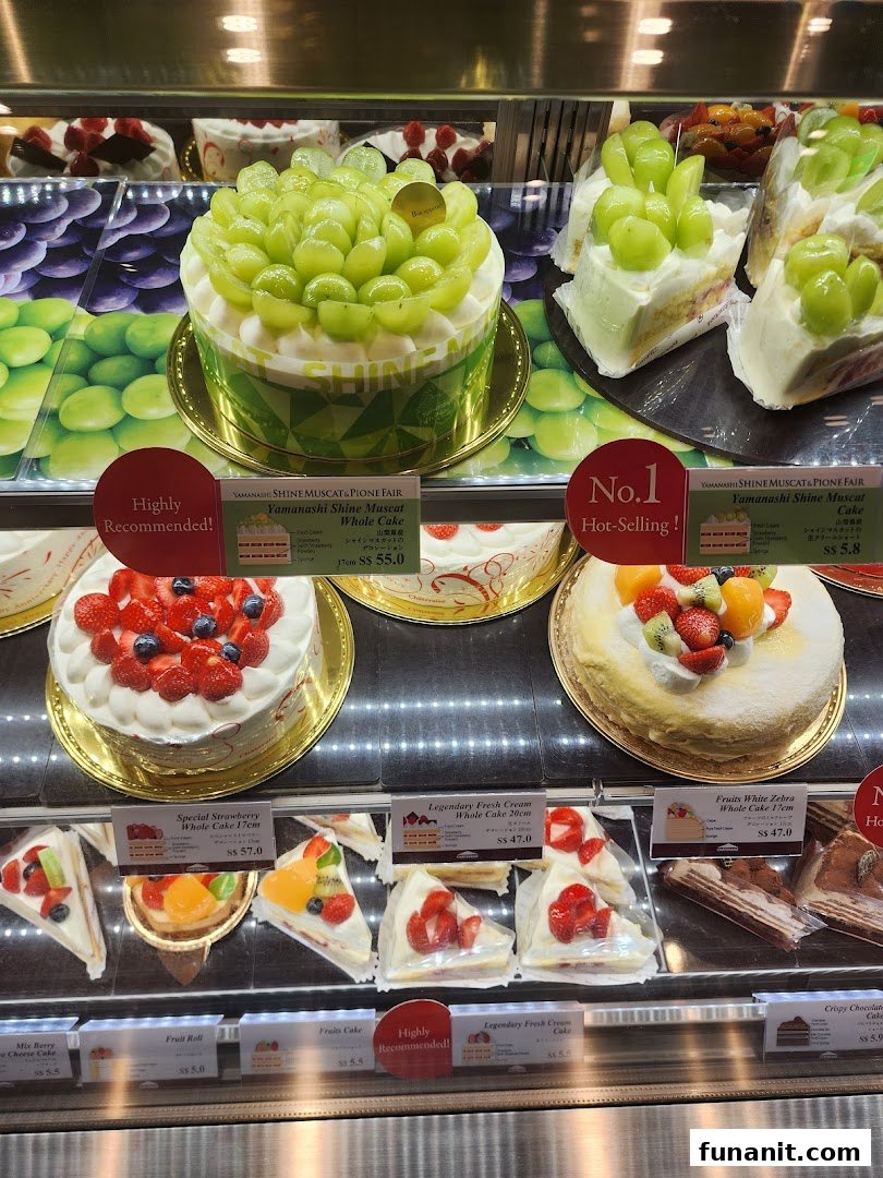A vibrant display of fresh fruit cakes and pastries in a Châteraisé dessert case.