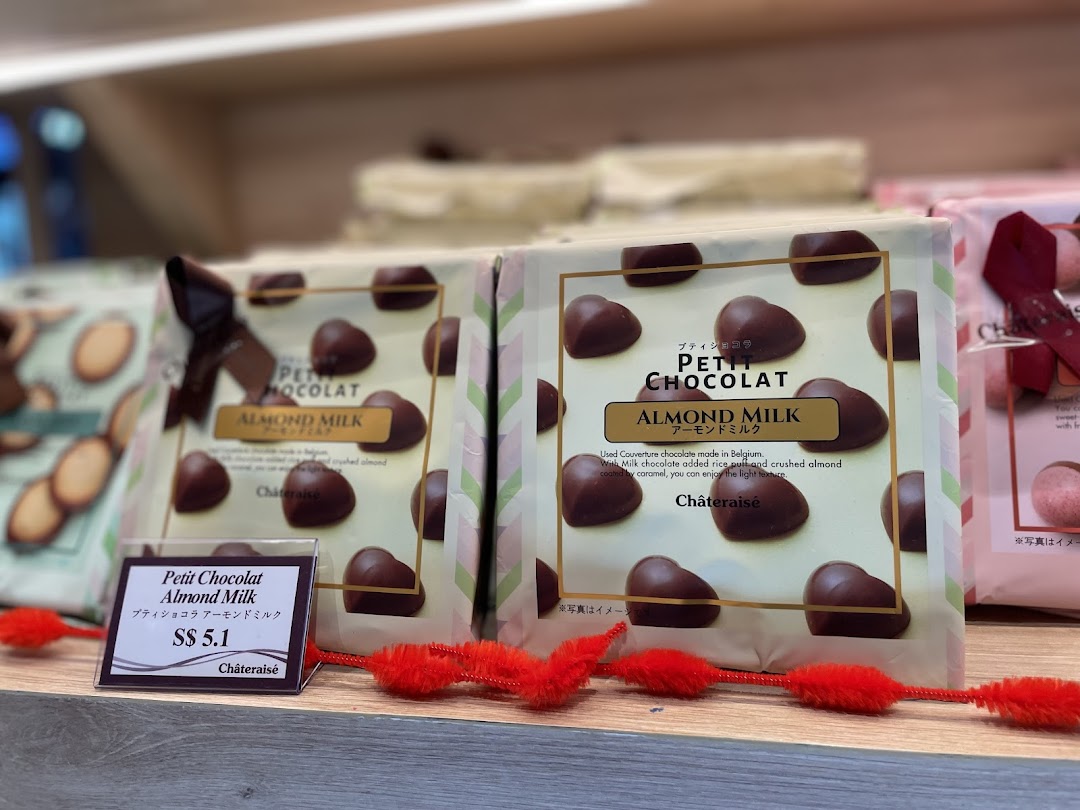 Close-up of Châteraisé's Petit Chocolat Almond Milk packages displayed on a shelf with a price tag.