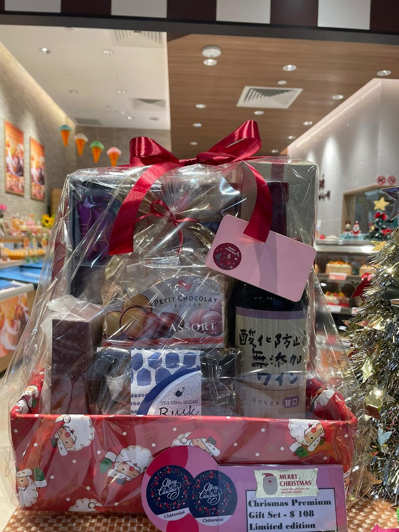 A festive Châteraisé Christmas Premium Gift Set, featuring various treats and a bottle, priced at $108.