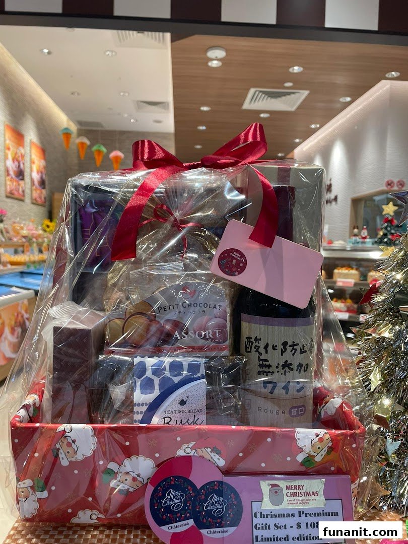 A festive Châteraisé Christmas Premium Gift Set, featuring various treats and a bottle, priced at $108.