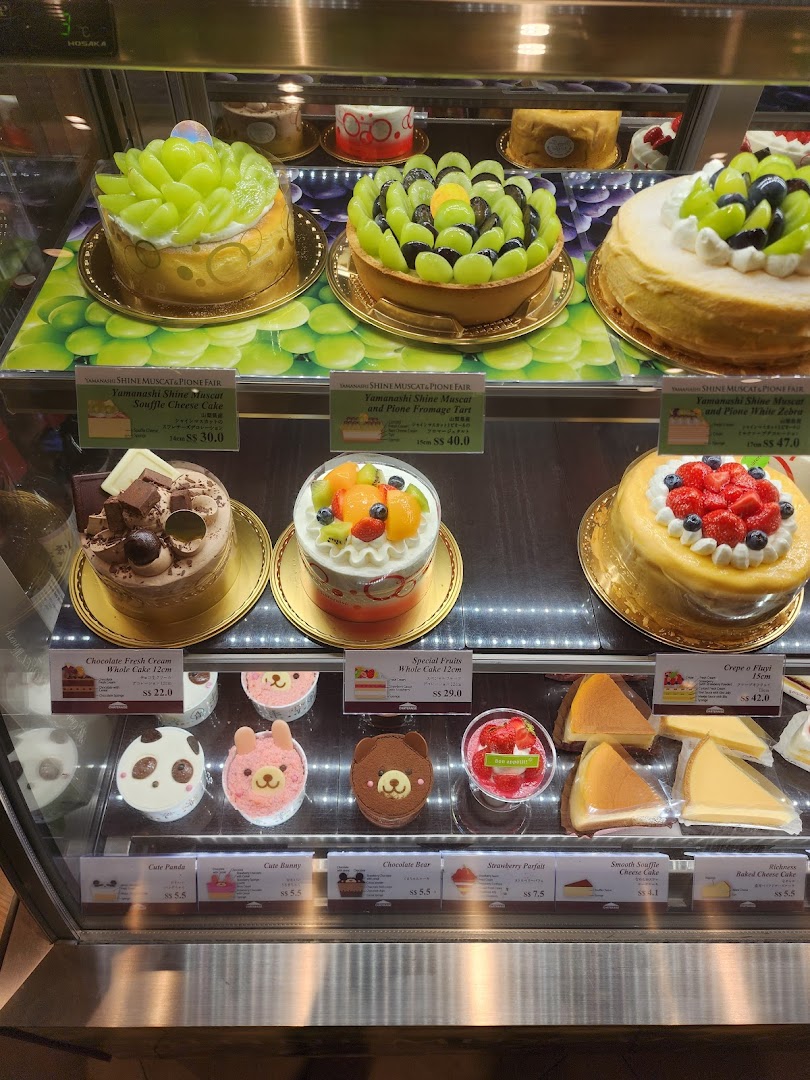 A vibrant display case showcasing a variety of exquisite cakes and delightful desserts at Châteraisé.