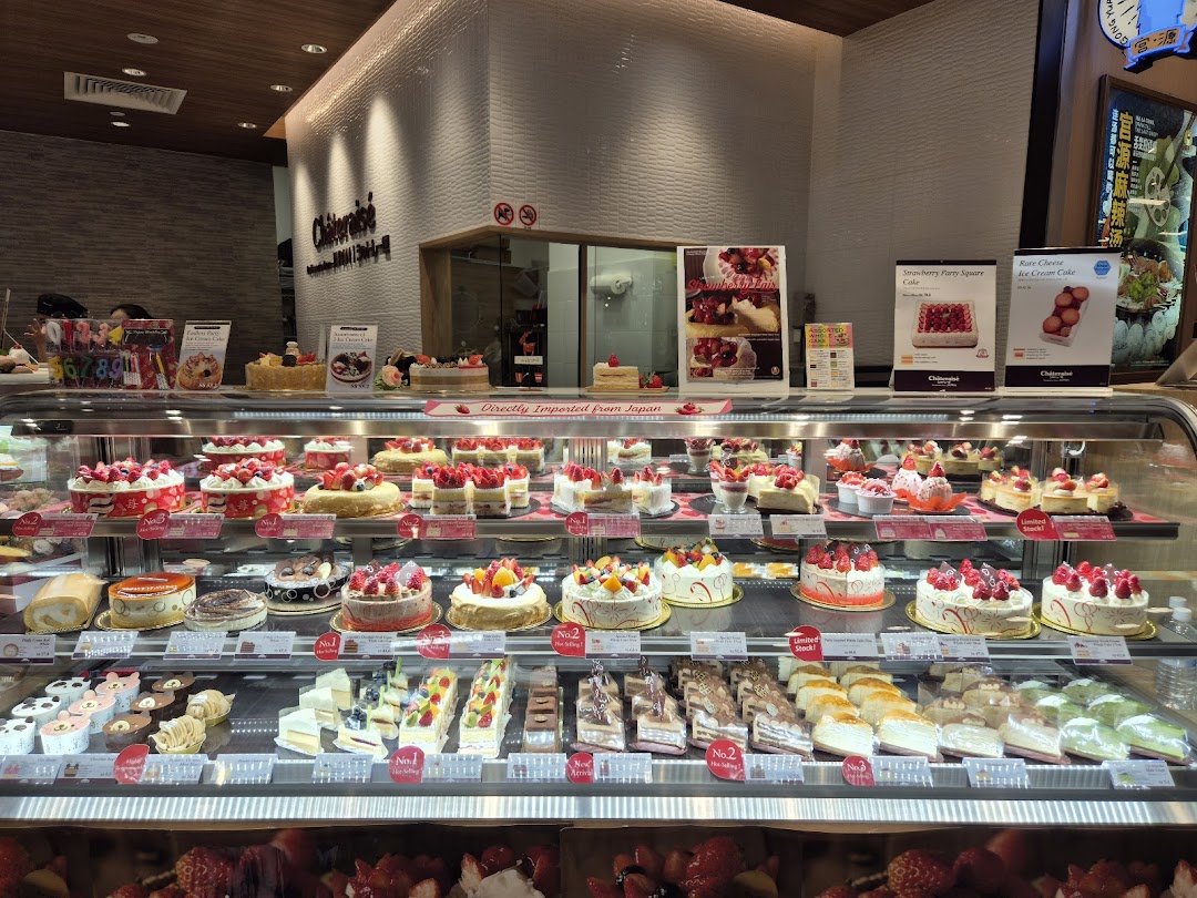 A vibrant display of fresh cakes and pastries in a brightly lit Châteraisé shop.