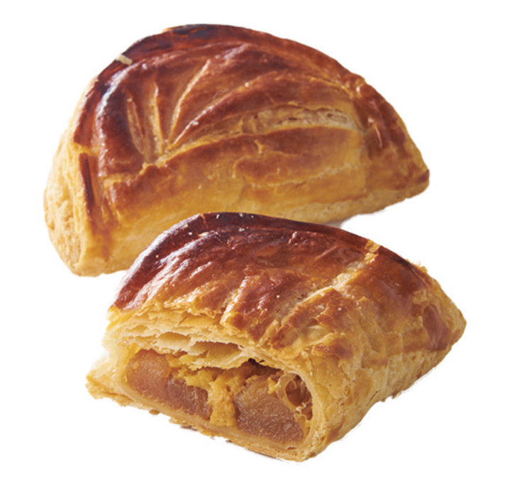Golden-brown puff pastries, one cut open to reveal a delicious fruit filling.