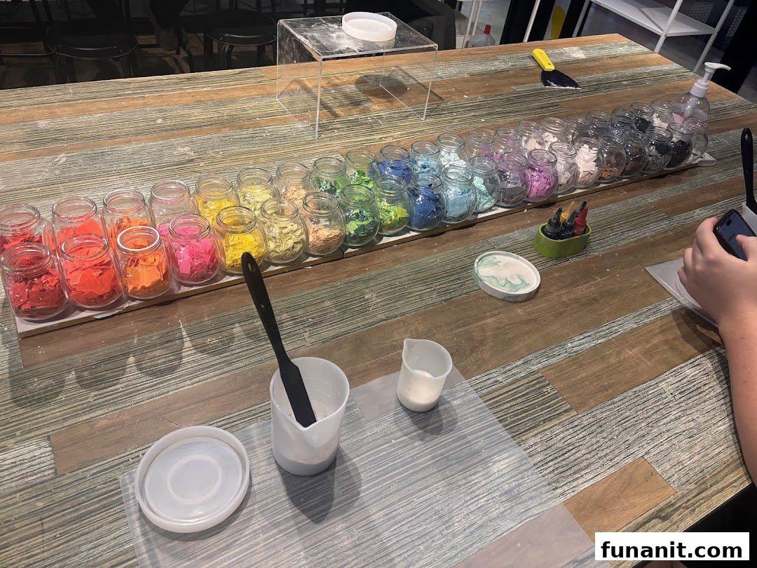 A crafting station with colorful flakes in jars, mixing tools, and molds for creative workshops.