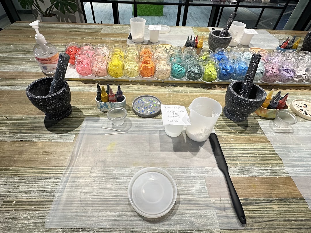 A workshop table at Chokmah with colorful materials, mortars, and tools for a creative activity.
