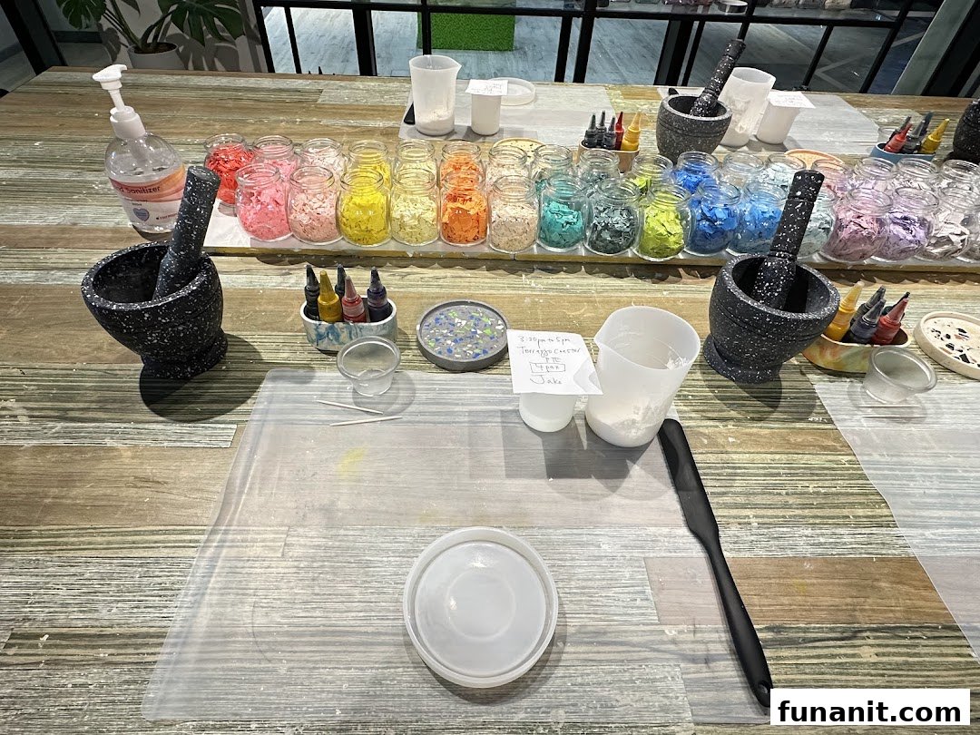 A workshop table at Chokmah with colorful materials, mortars, and tools for a creative activity.