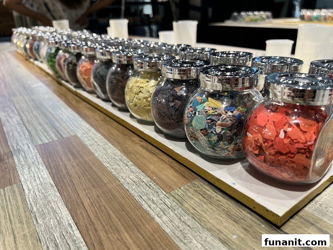 Rows of glass jars filled with colorful, textured materials for creative projects.