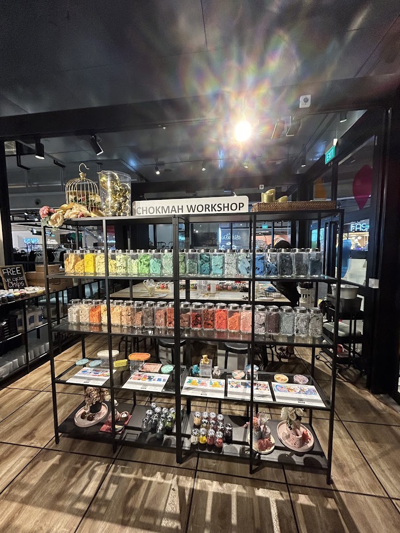 Interior view of Chokmah workshop, showcasing colorful materials in jars on display shelves.