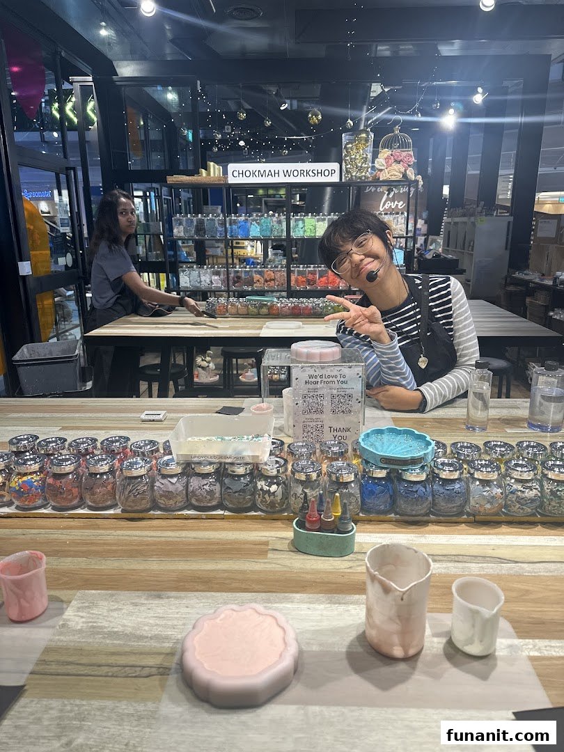 Two staff members in a vibrant Chokmah workshop, surrounded by crafting materials and projects.