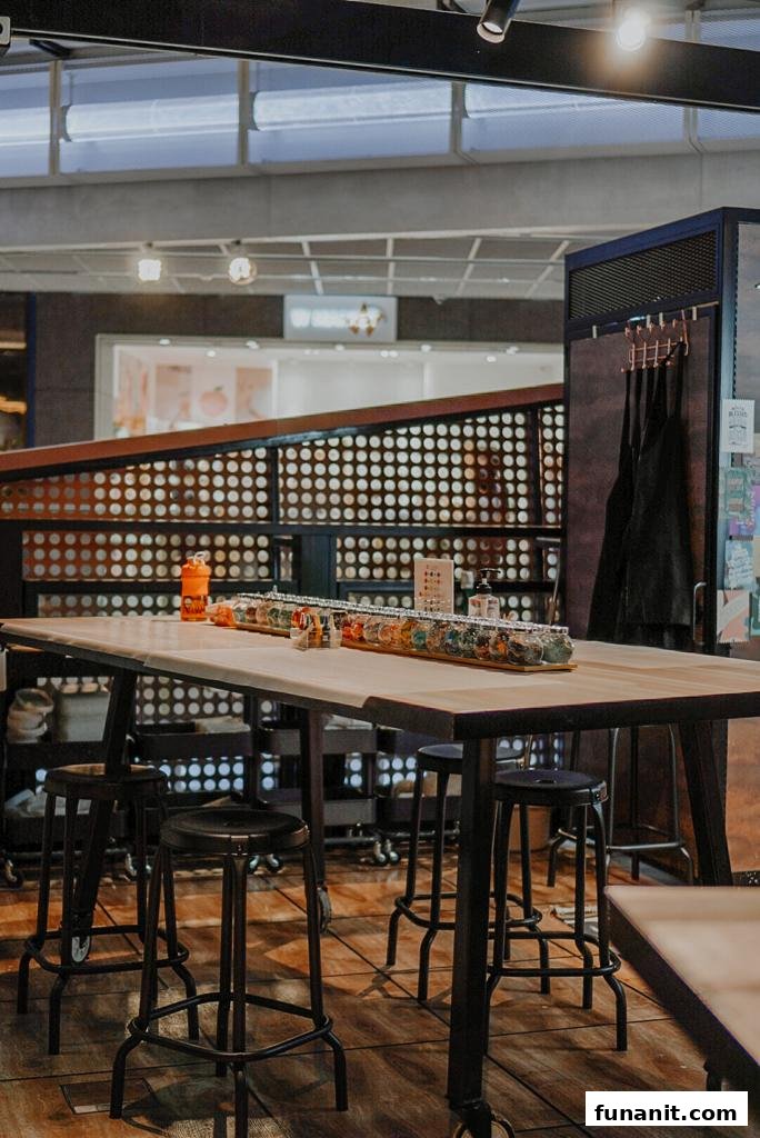 Interior view of Chokmah, featuring a long communal table with stools and colorful product displays.