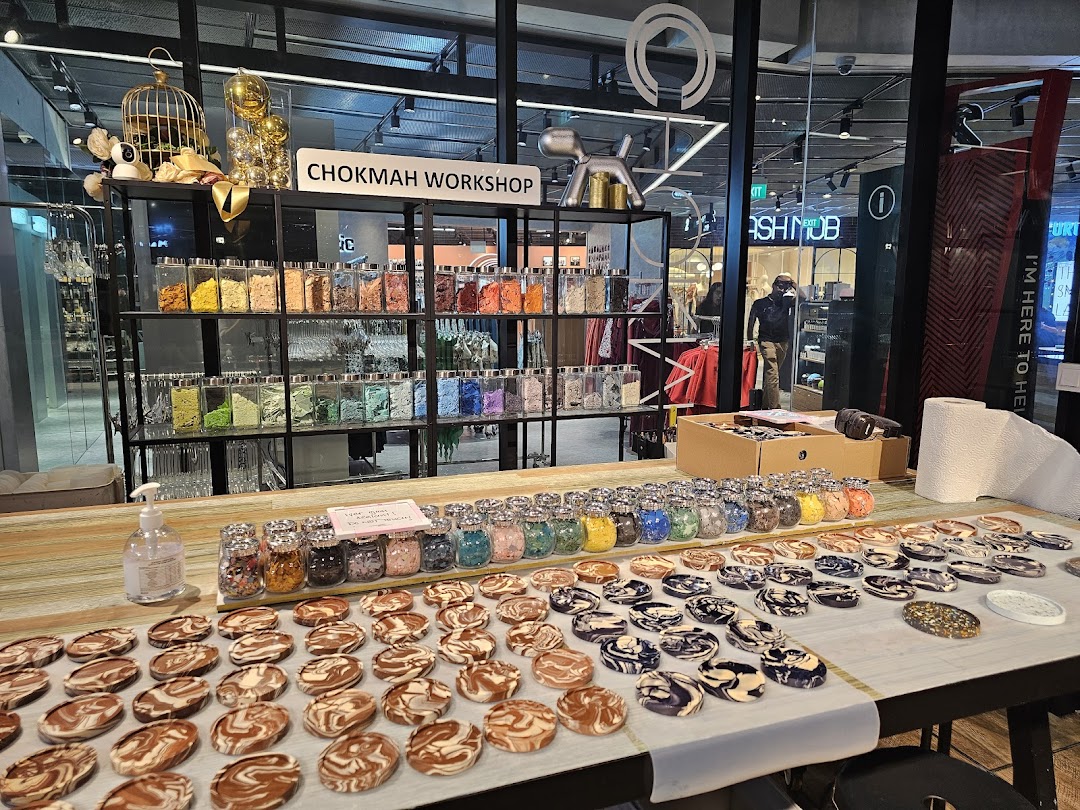 A Chokmah Workshop display featuring colorful materials in jars and numerous marbled craft items.