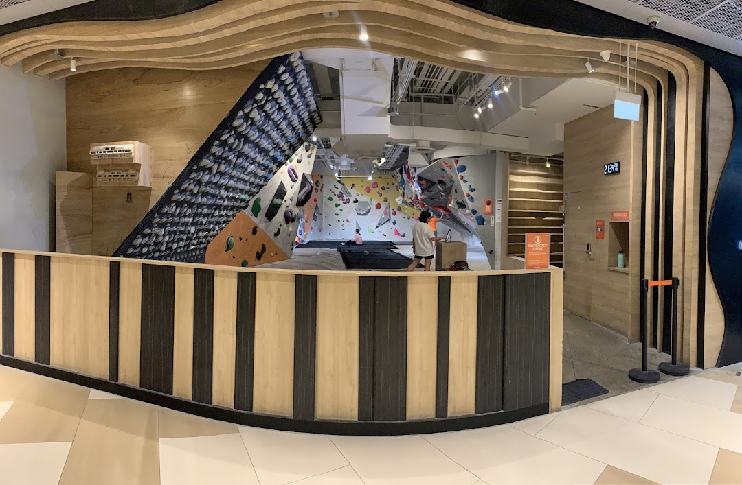 View of Climb Central Funan's entrance, showcasing bouldering walls and climbers inside.