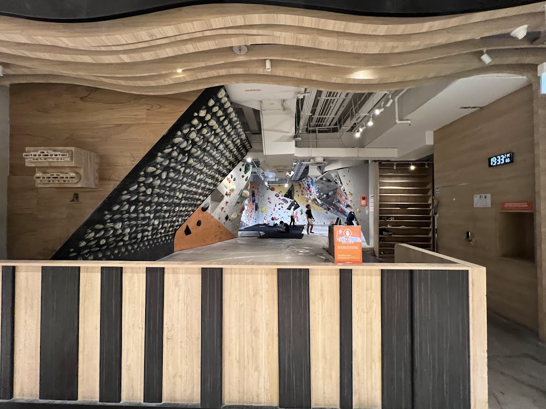 An interior view of Climb Central Funan, showcasing bouldering walls and climbing facilities.