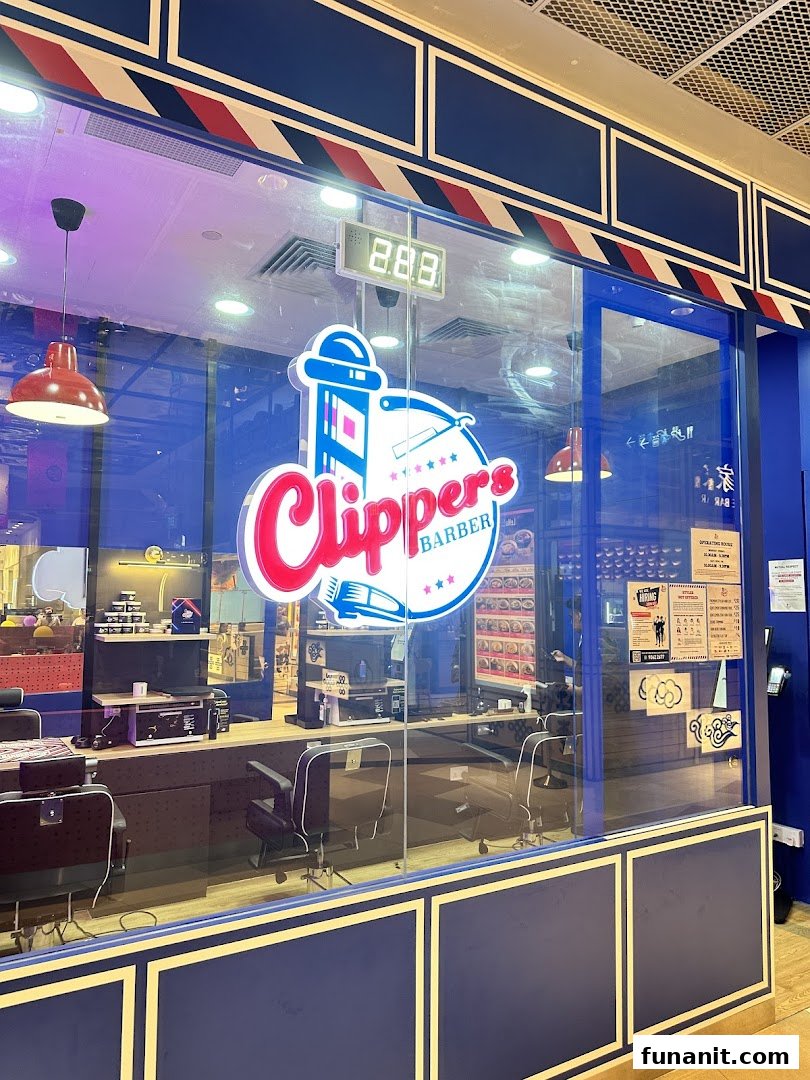 The vibrant blue storefront of Clippers Barber at Funan, showcasing its retro-inspired interior.