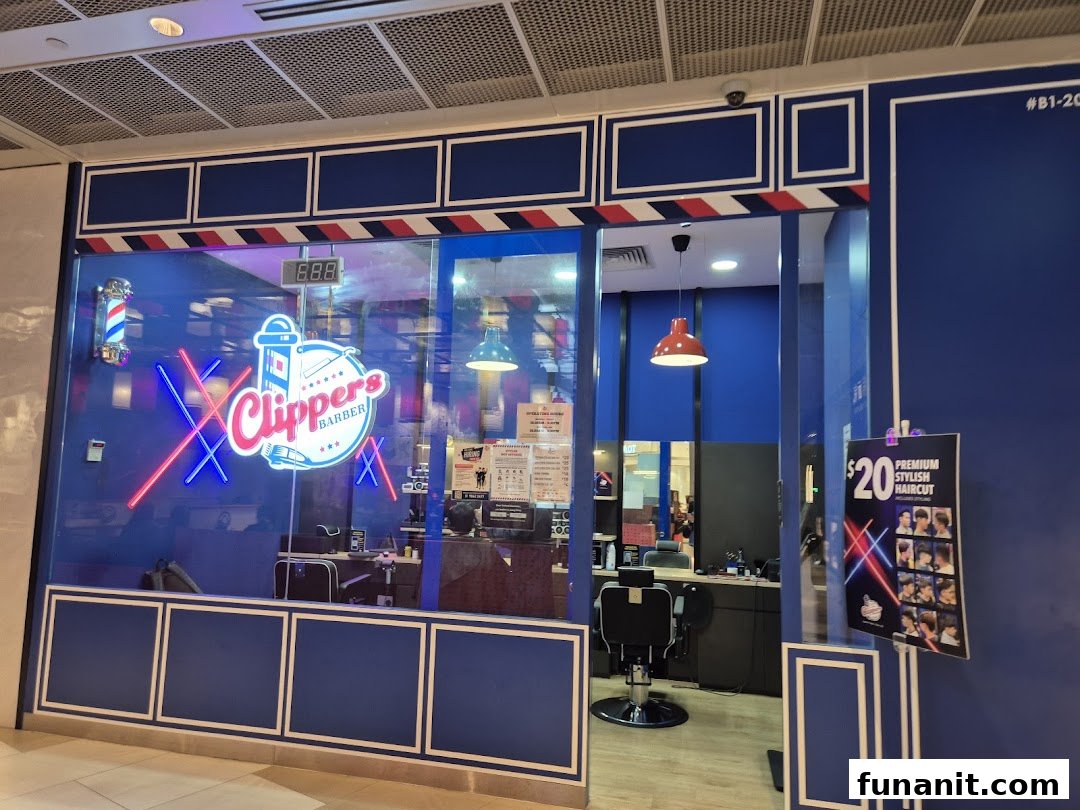 The vibrant blue shopfront of Clippers Barber Funan, featuring a neon logo and barber pole.