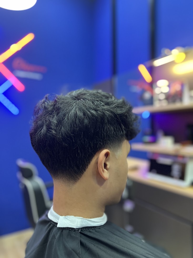 A customer receiving a fresh haircut with a clean fade at Clippers Barber Funan.