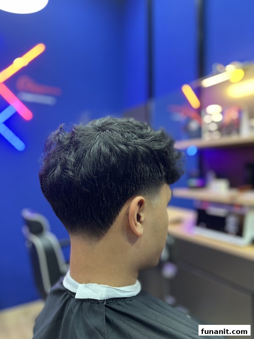 A customer receiving a fresh haircut with a clean fade at Clippers Barber Funan.