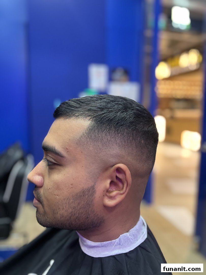 A man showcasing a fresh, sharp fade haircut at Clippers Barber Funan.