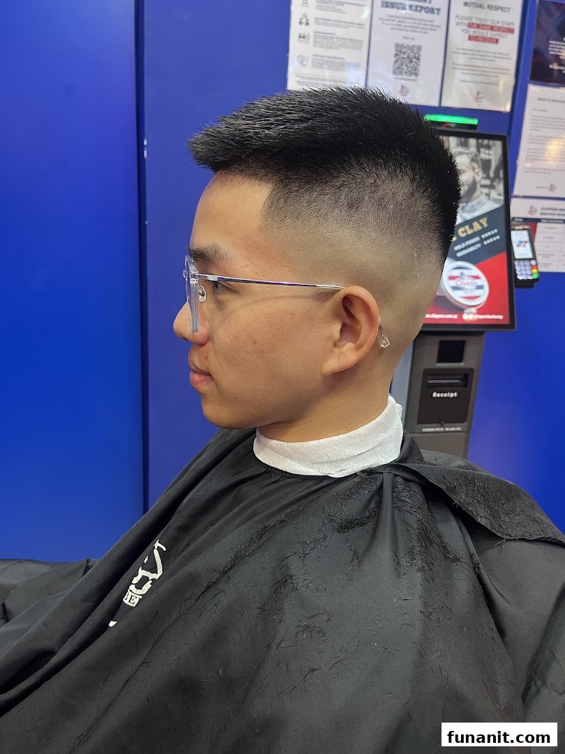 A customer showcasing a fresh fade haircut at Clippers Barber Funan, highlighting the shop's styling expertise.