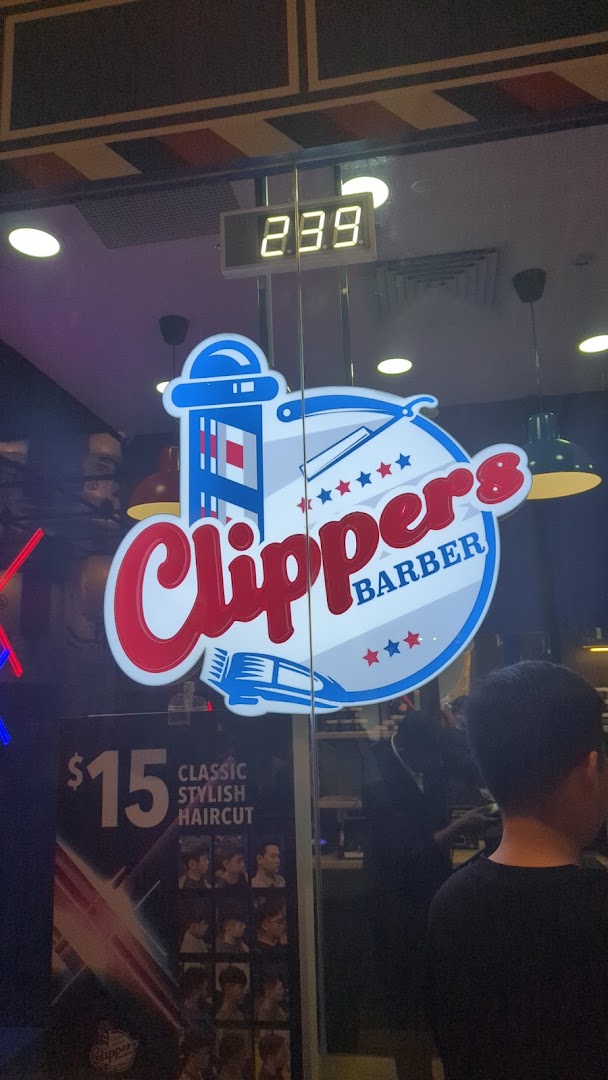 The shopfront of Clippers Barber Funan, featuring its logo and a $15 classic stylish haircut promotion.