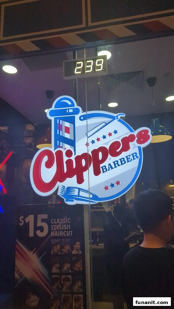 The shopfront of Clippers Barber Funan, featuring its logo and a $15 classic stylish haircut promotion.