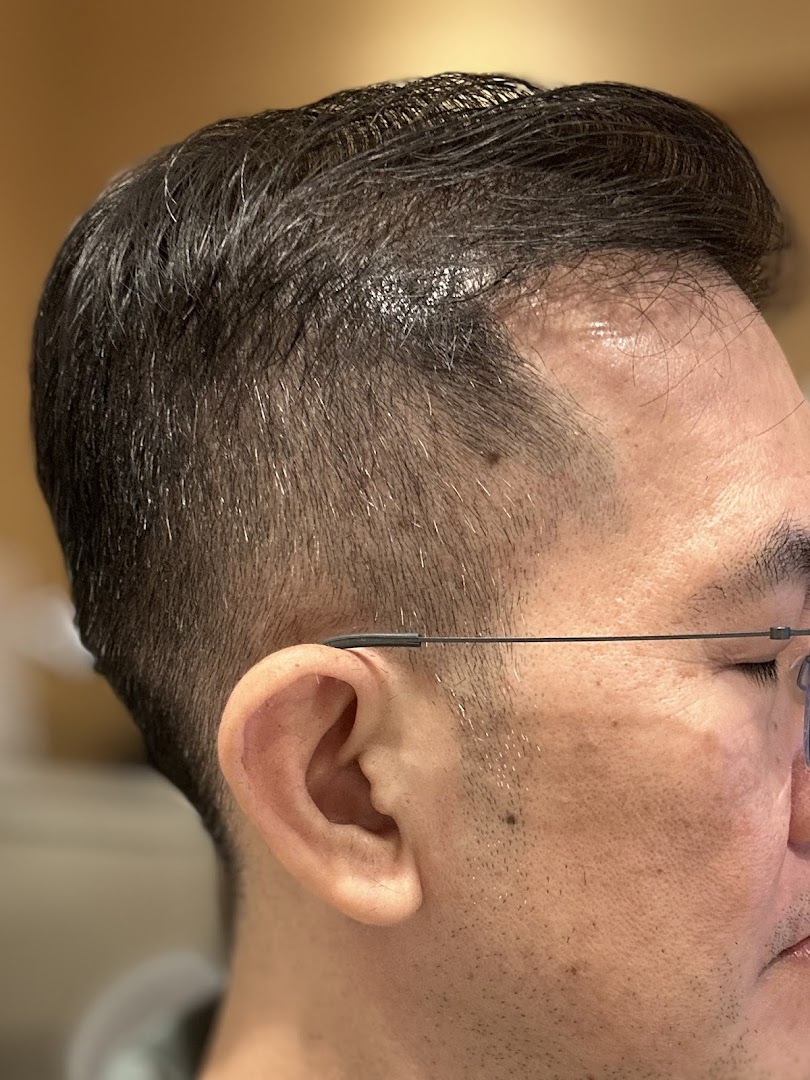 Close-up of a man's head showcasing a fresh, precise haircut and fade.