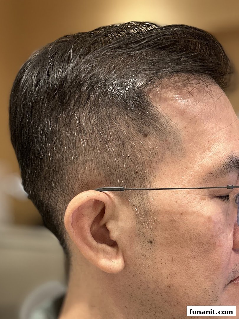 Close-up of a man's head showcasing a fresh, precise haircut and fade.