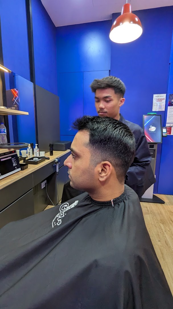 A customer receives a fresh haircut from a barber in a modern barbershop setting.