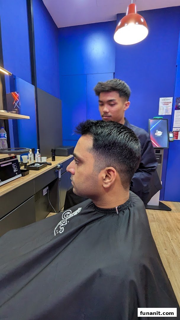A customer receives a fresh haircut from a barber in a modern barbershop setting.