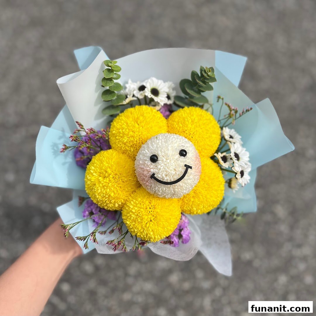 A hand holds a vibrant flower bouquet featuring a smiley face bloom surrounded by yellow flowers.