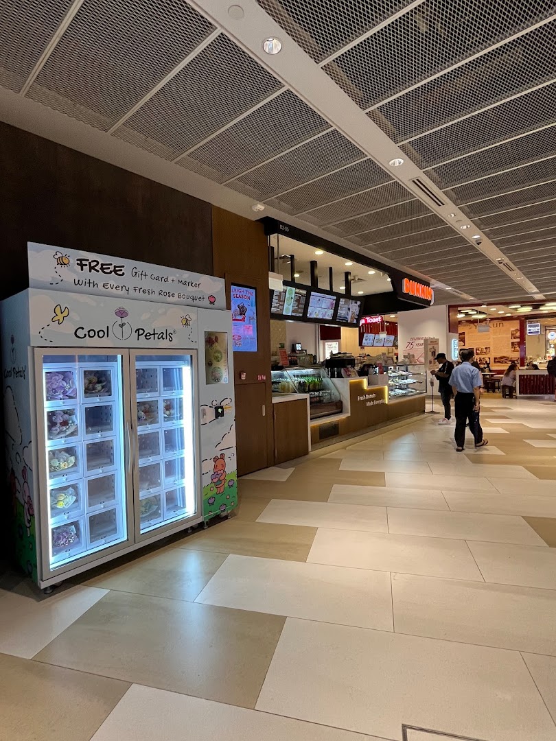 A Cool Petals vending machine offering fresh rose bouquets and gift cards in a mall setting.