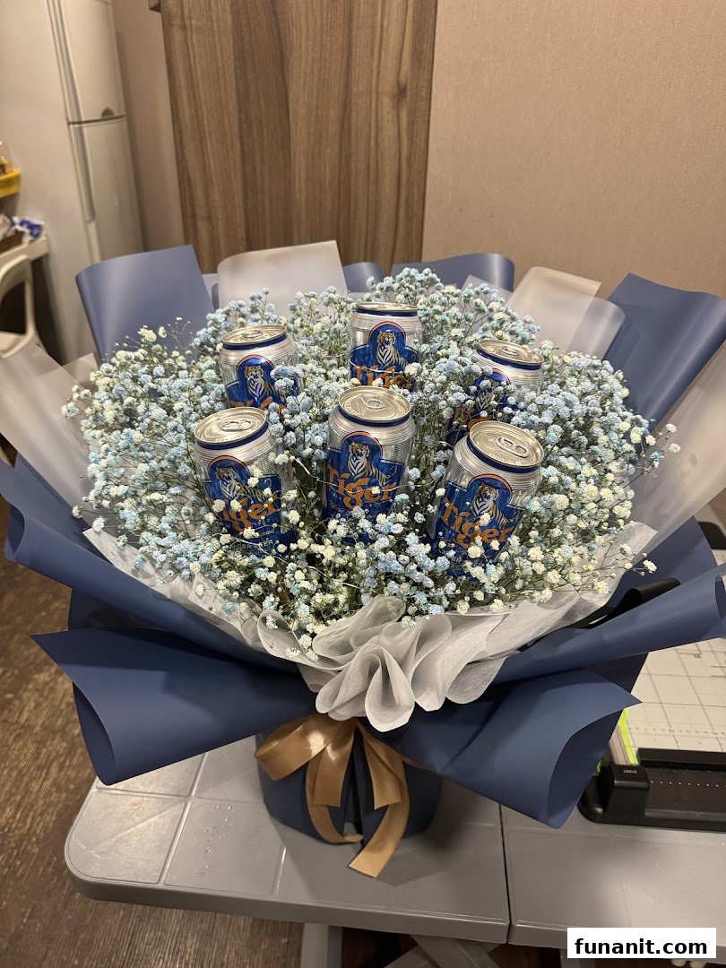 A unique bouquet featuring Tiger Beer cans nestled among blue and white baby's breath flowers.