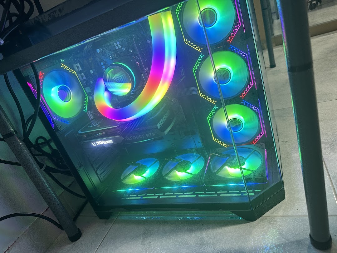 A high-performance gaming PC with vibrant RGB lighting and multiple cooling fans.