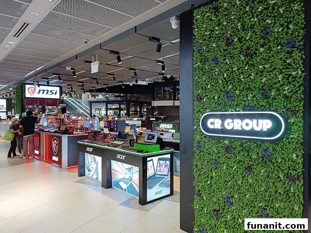 Interior view of CR GROUP electronics store showcasing laptops, gaming PCs, and tech accessories.