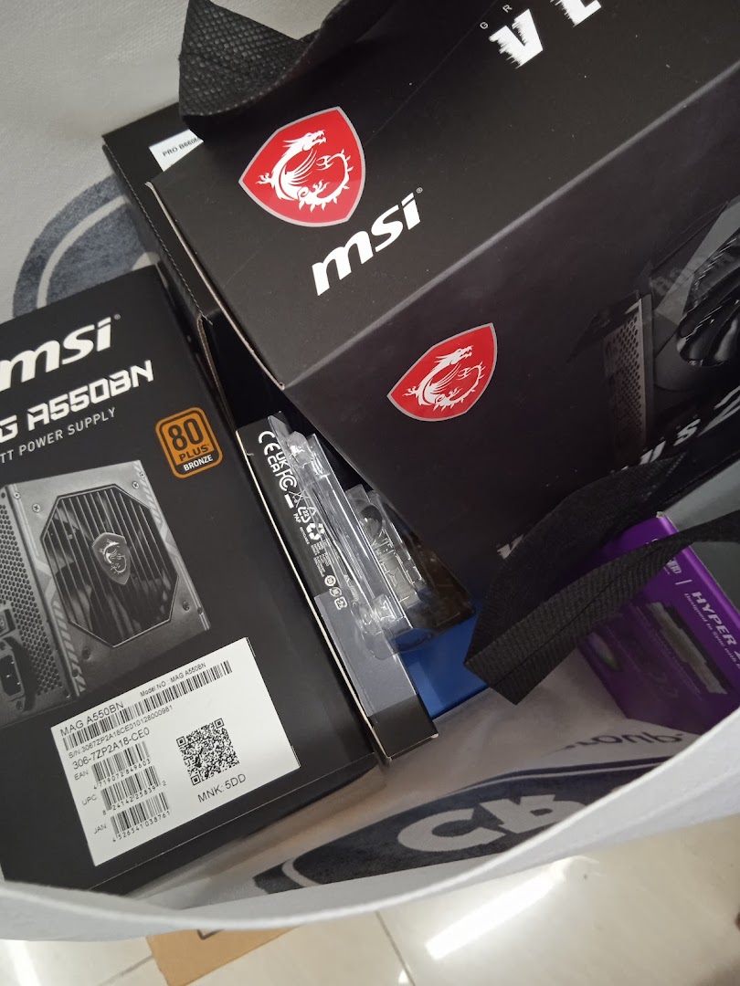 MSI computer components, including a power supply, in a shopping bag.