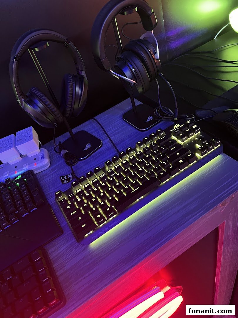 A vibrant display of gaming headsets and illuminated keyboards on a desk, showcasing modern tech.