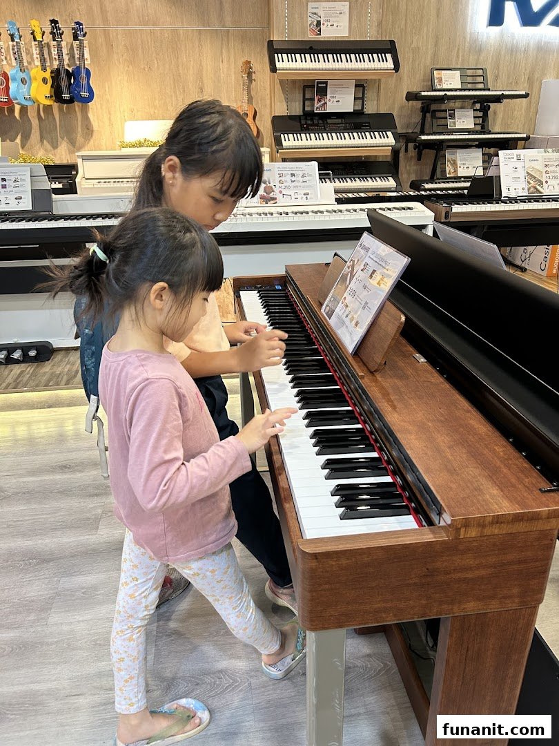 Two children are engaged in playing a digital piano within a music instrument store.
