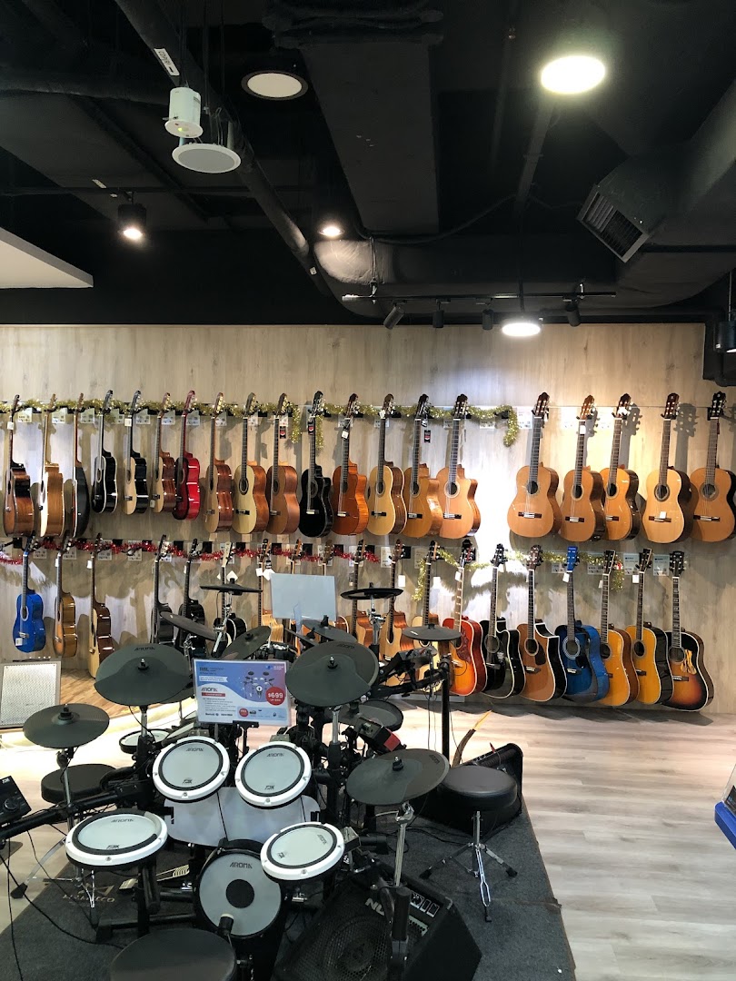 An interior view of Cristofori Music, showcasing a wide array of guitars and an electronic drum set.