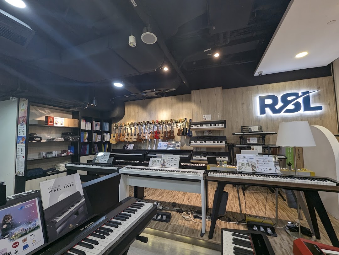 Interior view of Cristofori Music, showcasing a wide array of pianos, keyboards, and ukuleles.