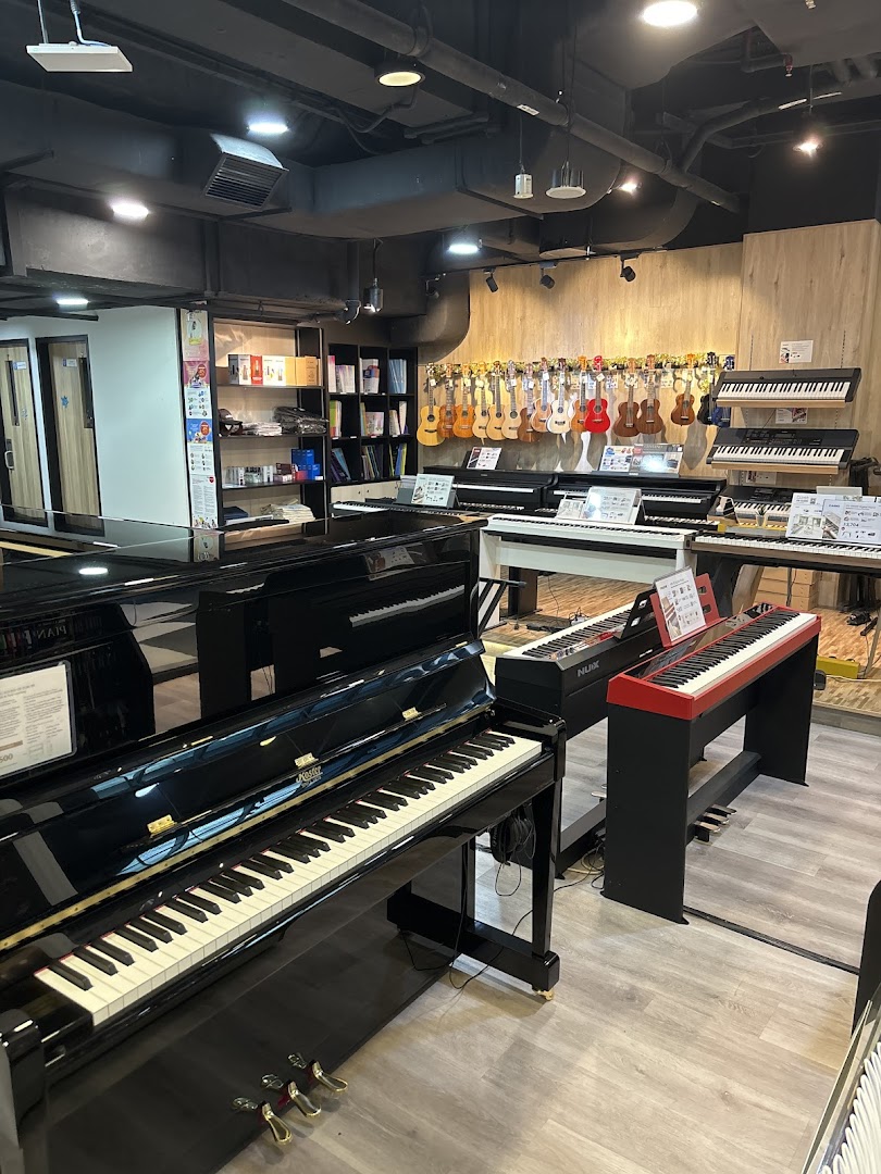 Interior view of Cristofori Music Experiential Center, showcasing pianos, keyboards, and ukuleles.