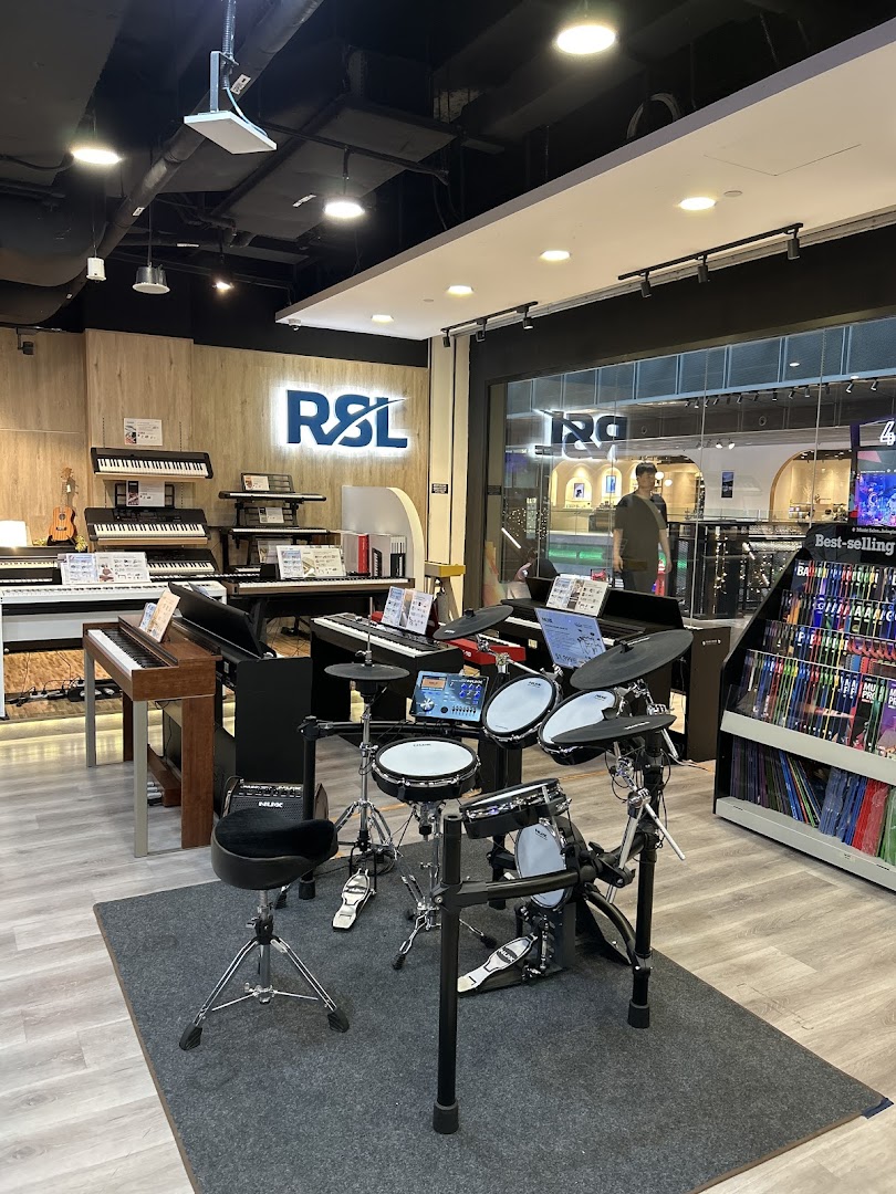 Interior of Cristofori Music Experiential Center, showcasing pianos, keyboards, and an electronic drum set.