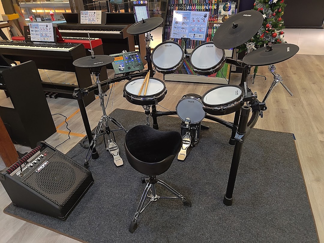 An electronic drum set and keyboards displayed in a music store, ready for exploration.