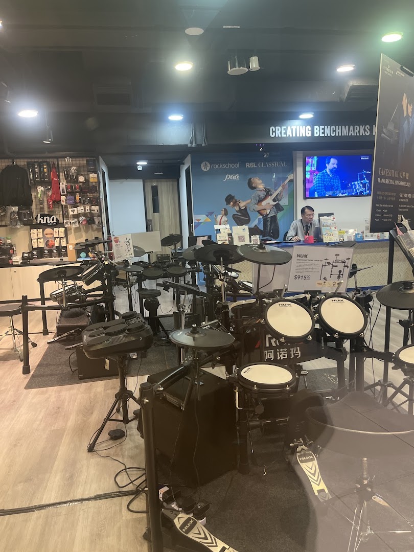 Interior view of Cristofori Music Experiential Center showcasing electronic drum kits and a service counter.