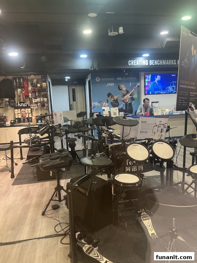 Interior view of Cristofori Music Experiential Center showcasing electronic drum kits and a service counter.