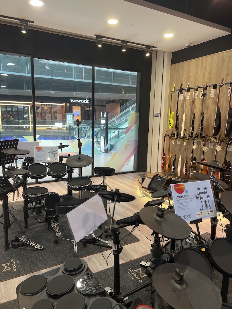 Interior view of Cristofori Music, showcasing various electronic drum kits and guitars.