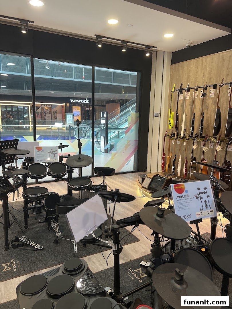 Interior view of Cristofori Music, showcasing various electronic drum kits and guitars.
