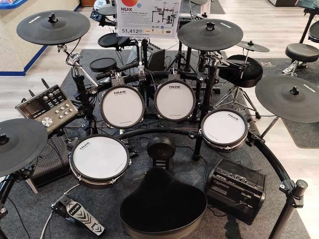 A NUX electronic drum kit displayed in a music store, ready for demonstration.