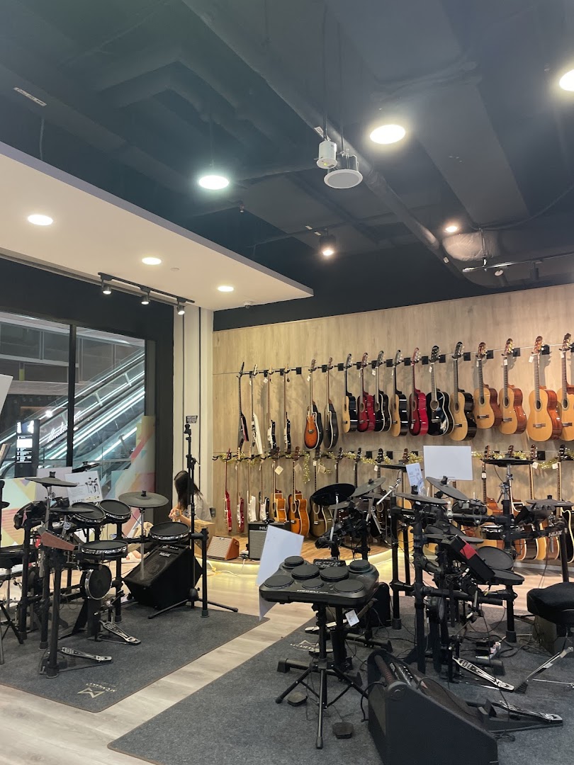 Interior of Cristofori Music Experiential Center showcasing guitars, drums, and other musical instruments.